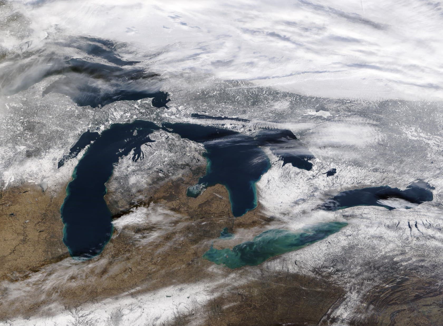 The Great Lakes from NASA's MODIS satellite after a winter storm, deep blue water surrounded by snow-covered land