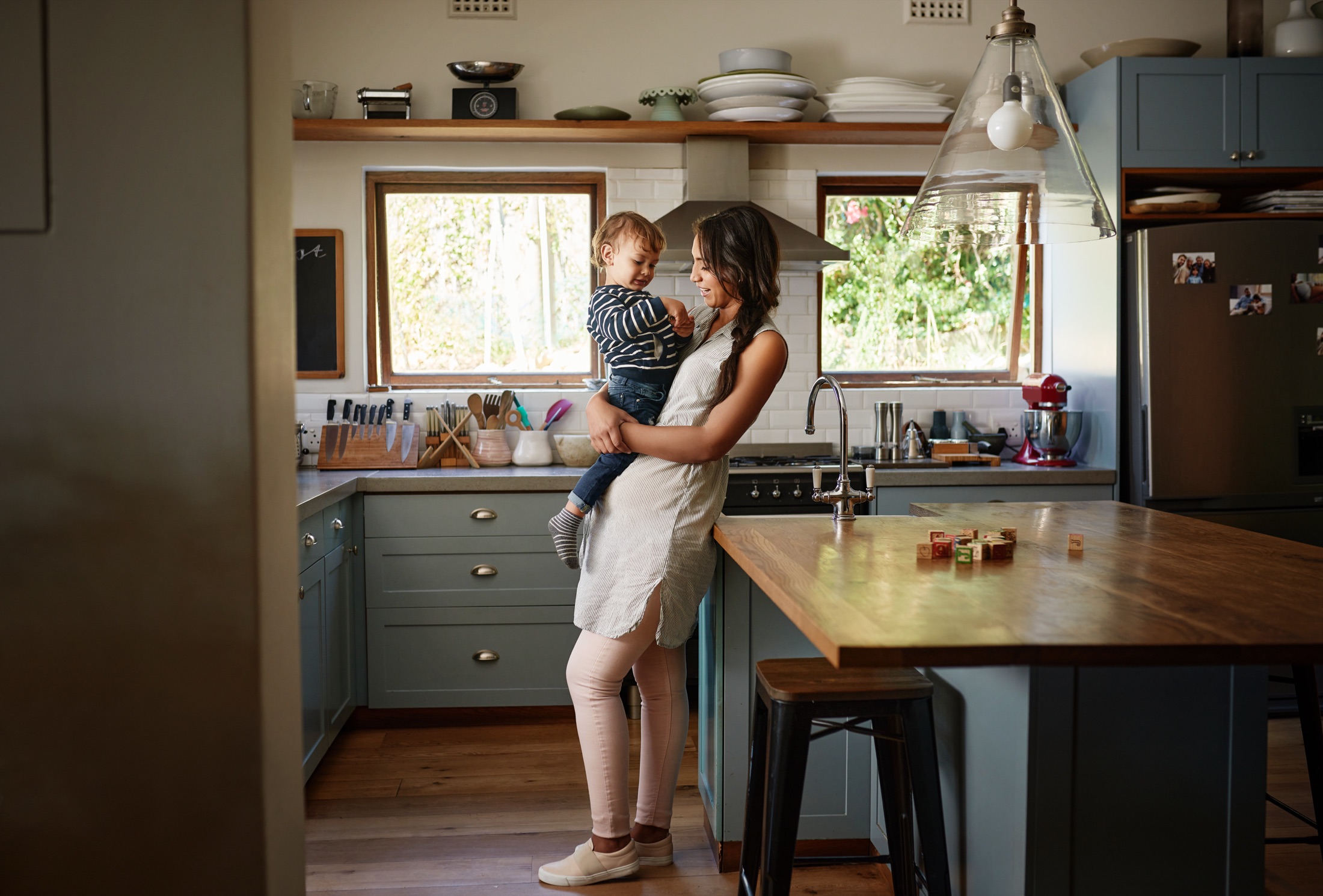 A parent and child at home in their kitchen, feeling prepared